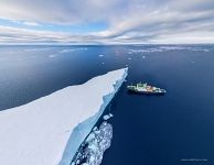 Iceberg and Polar Pioneer expedition ship. Antarctica Iceberg and Polar Pioneer expedition ship. Antarctica