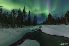 On the banks of a winter river at night